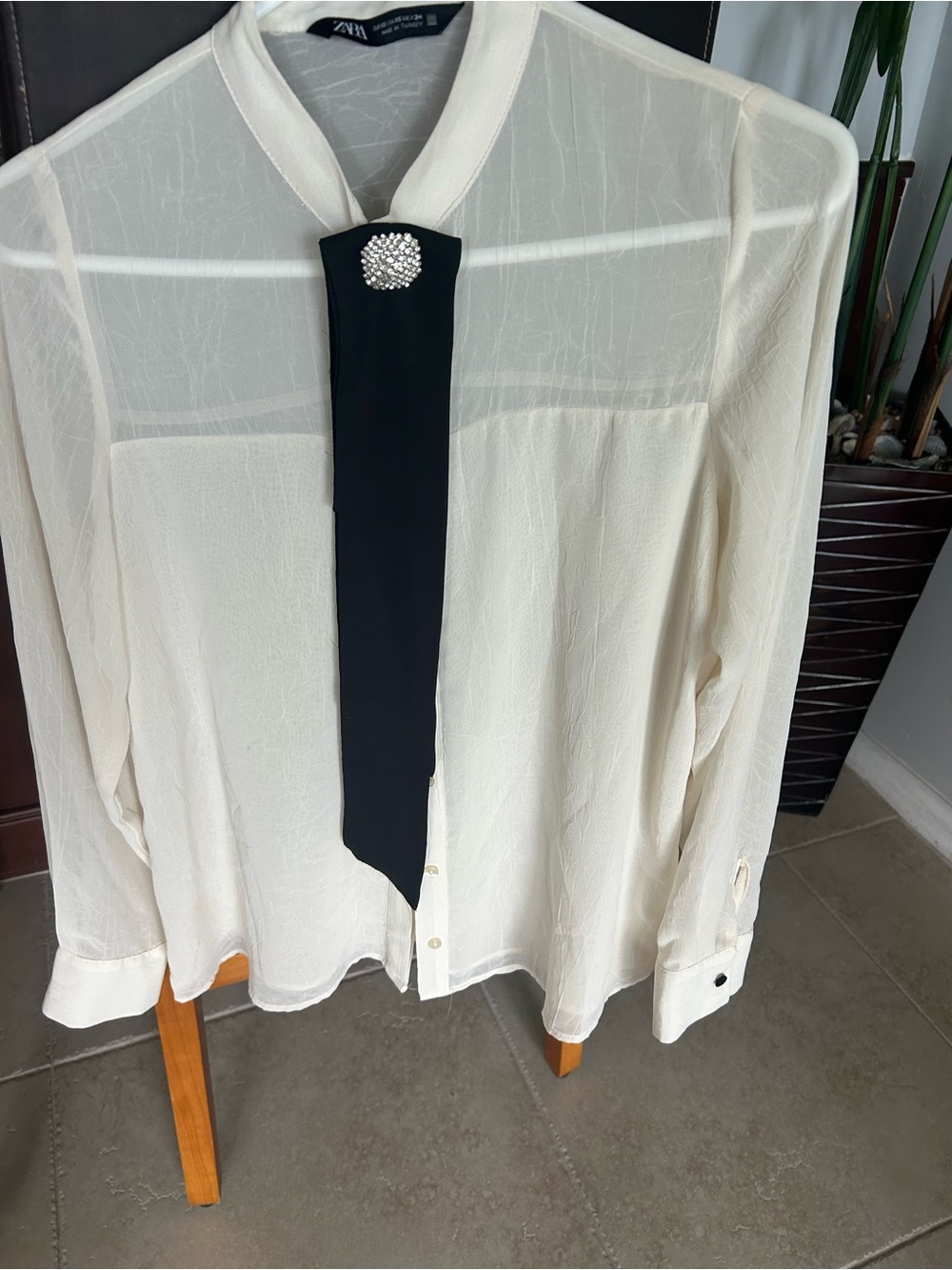 Zara Cream Sheer Blouse with Black Tie and Rhinestone Brooch